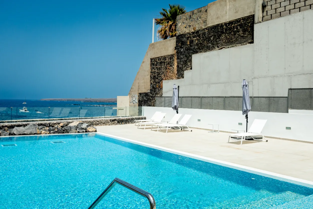 Vista del Silencio - pool-with-stone-wall-and-boats-view